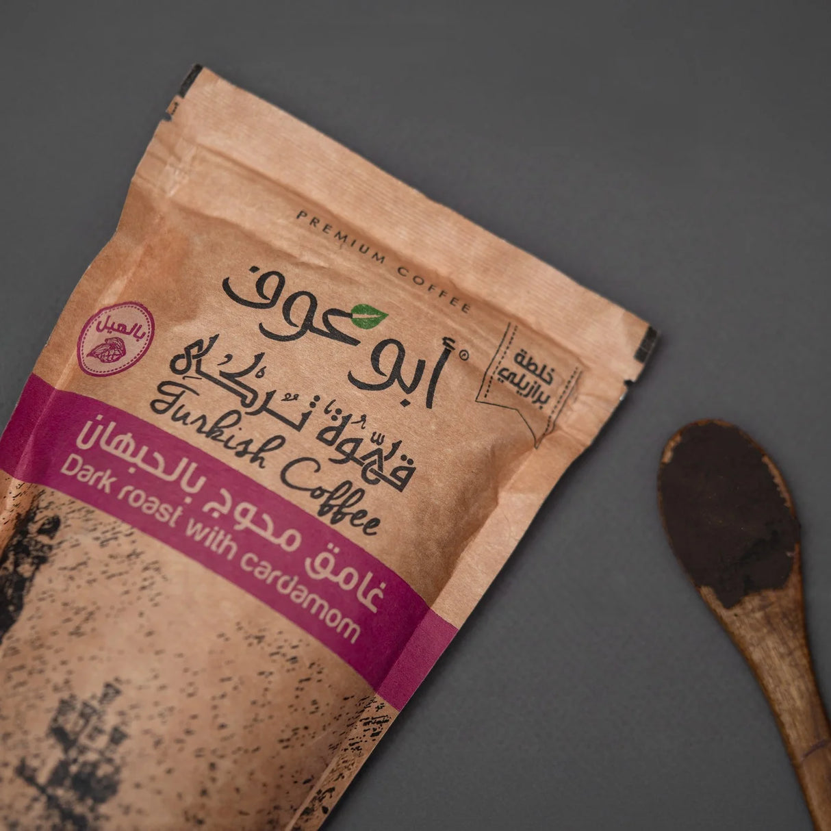 Side view of Shakk dark roast coffee and wooden spoon at Elsouk