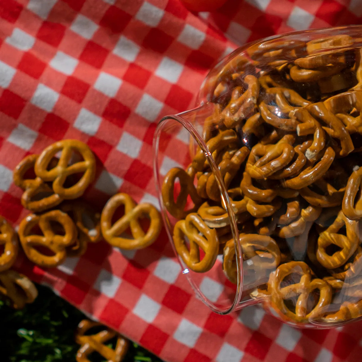 Crispy ketchup pretzels with tomatoes on green grass photo from Elsouk