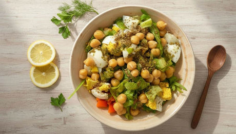 Fresh Chickpea and Egg Salad bowl with chickpeas eggs vegetables and lemon slices