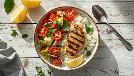 Grilled chicken dishes recipes with grilled chicken breast white rice and fresh vegetable salad on wooden table