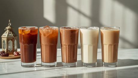 Ramadan juice glasses of licorice doum carob coconut and sobia arranged on marble