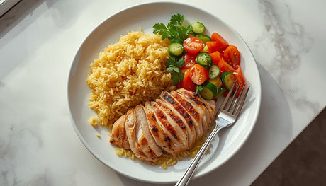Rice Pilaf with Grilled Chicken on white plate with fresh salad side