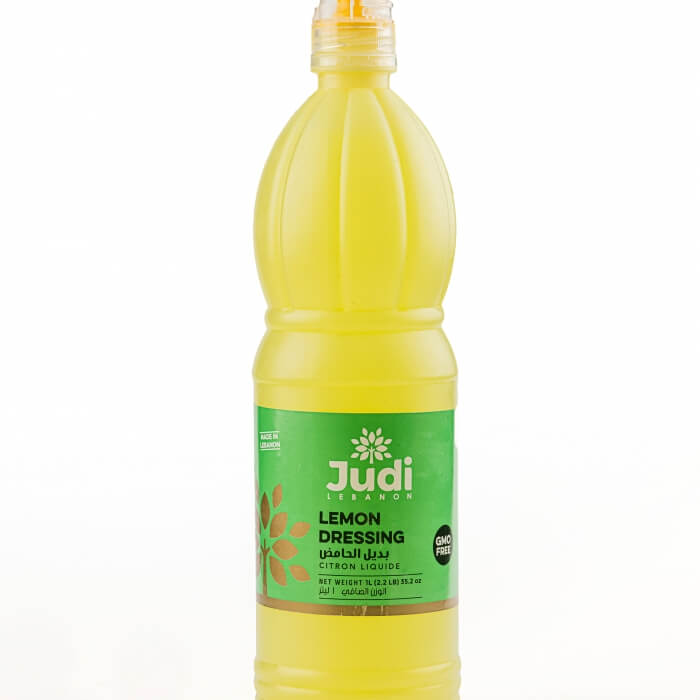Judi Lemon Juice 1L bottle with fresh lemons and juice pouring into a glass, showcasing the product's natural lemon flavor.