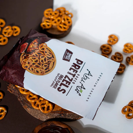 BBQ flavor pretzels beside pack and dip setup on dark surface Elsouk