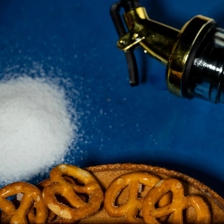 Salt and pepper with pretzels and oil bottle closeup by Elsouk