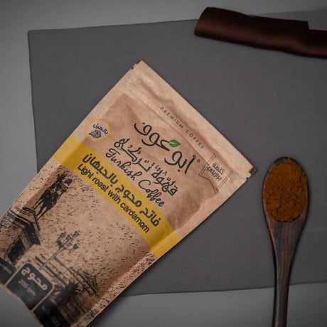 Shakk Coffee light roast pack beside cardamom spoon styled Elsouk