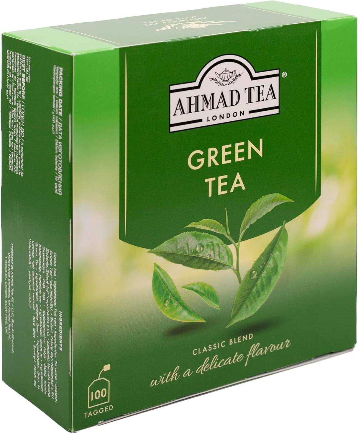 A box of Ahmad Tea Green Tea with green tea leaves and packaging, showcasing the brand and fresh, natural tea leaves inside.