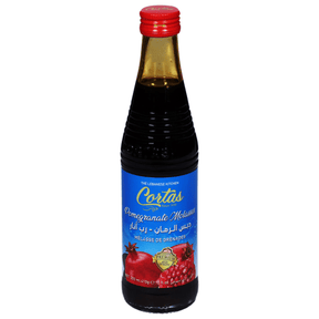 Cortas pomegranate molasses bottle with label, showing dark red, thick syrup used in cooking and baking.