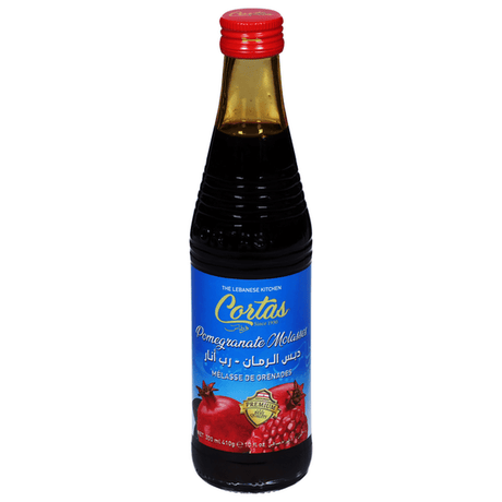 Cortas pomegranate molasses bottle with label, showing dark red, thick syrup used in cooking and baking.