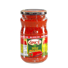 Oncu mild pepper paste in a 700g jar, smooth and vibrant red, ideal for adding gentle heat and flavor to dishes.