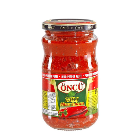Oncu mild pepper paste in a 700g jar, smooth and vibrant red, ideal for adding gentle heat and flavor to dishes.