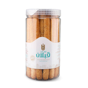 Qabalan sesame bread sticks arranged on a plate, crispy and topped with sesame seeds, ready to serve as a snack or appetizer.