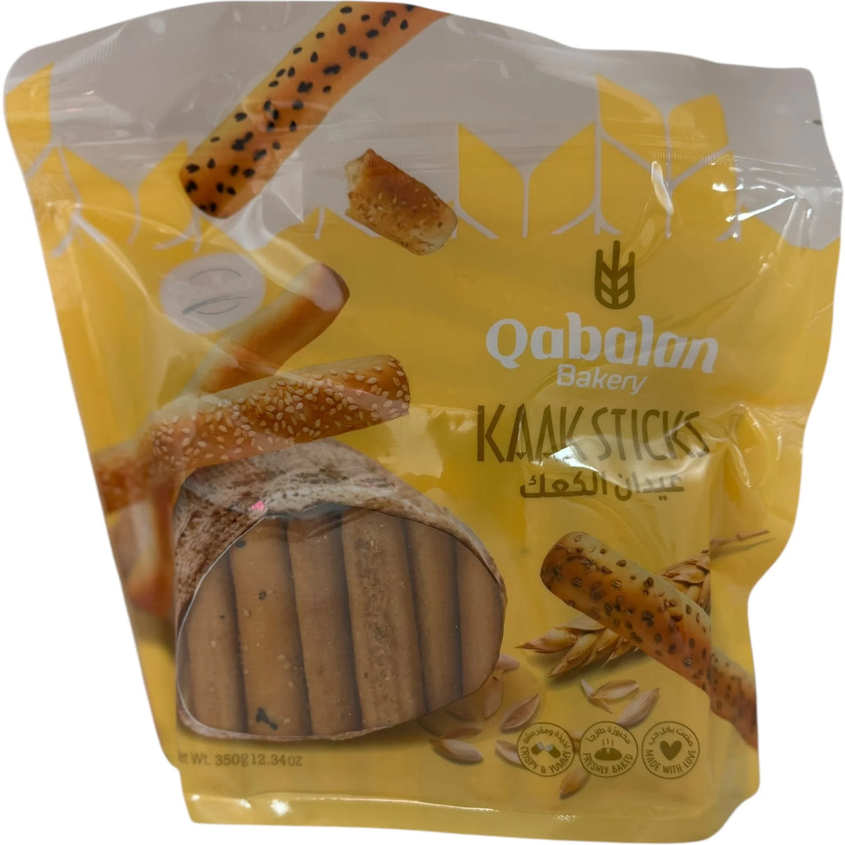 Qabalan Kaak sticks, crunchy baked bread snacks, golden brown, with sesame seeds, ideal for snacking or sharing.