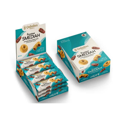 Qabalan Smediah with Dates, traditional Middle Eastern pastry served with fresh dates and nuts, in a decorative plate.