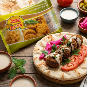Frozen Basma Falafel with chickpeas, golden-brown, crispy exterior, served in a bowl with fresh herbs and vegetables.
